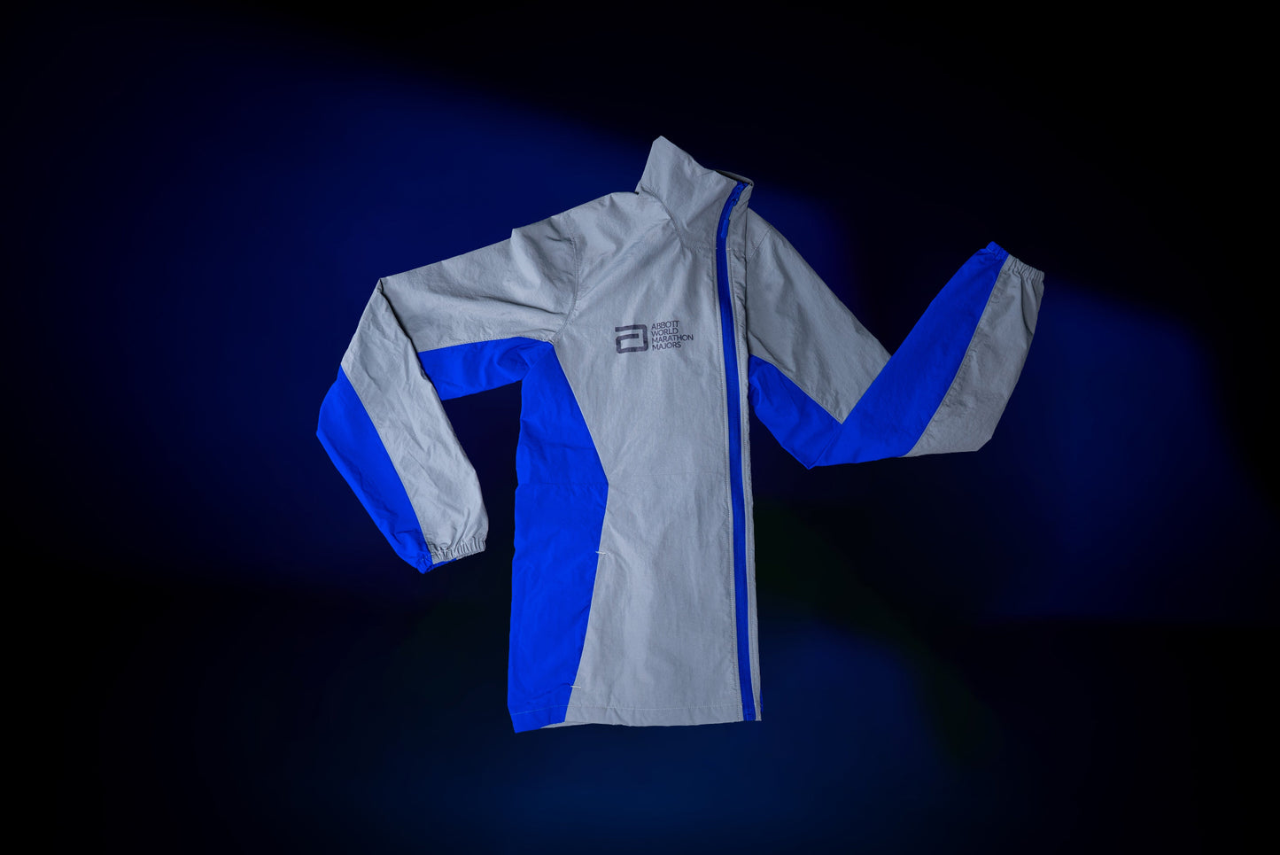 White and blue jacket with a logo on a dark background