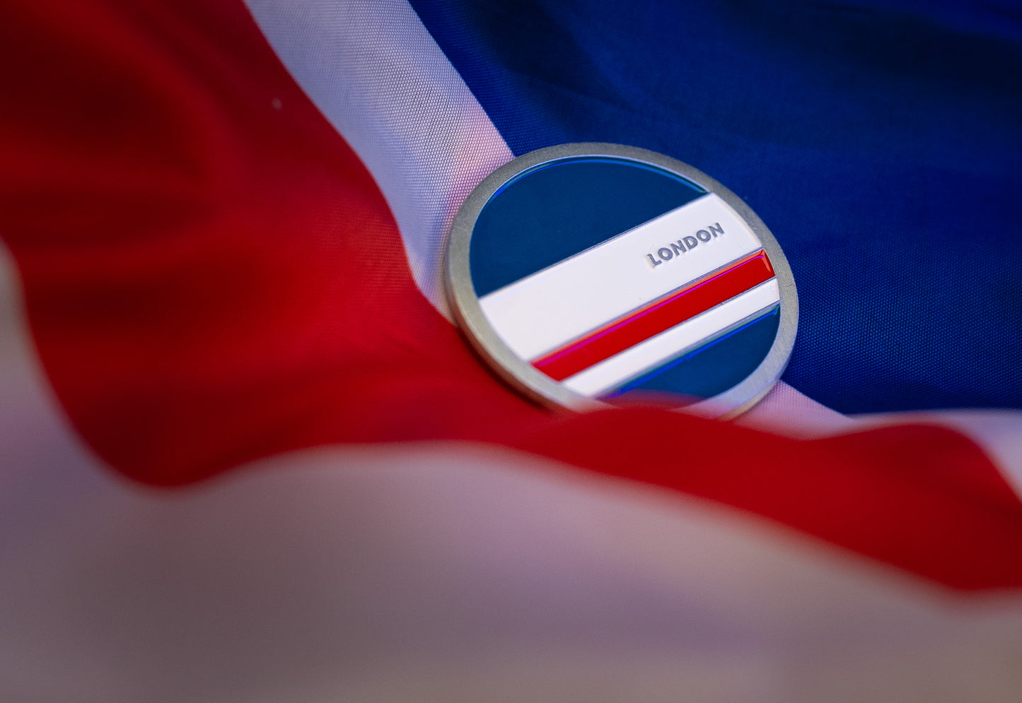 Abbott World Marathon Majors London collectible coin resting on a blue, white, and red fabric background.